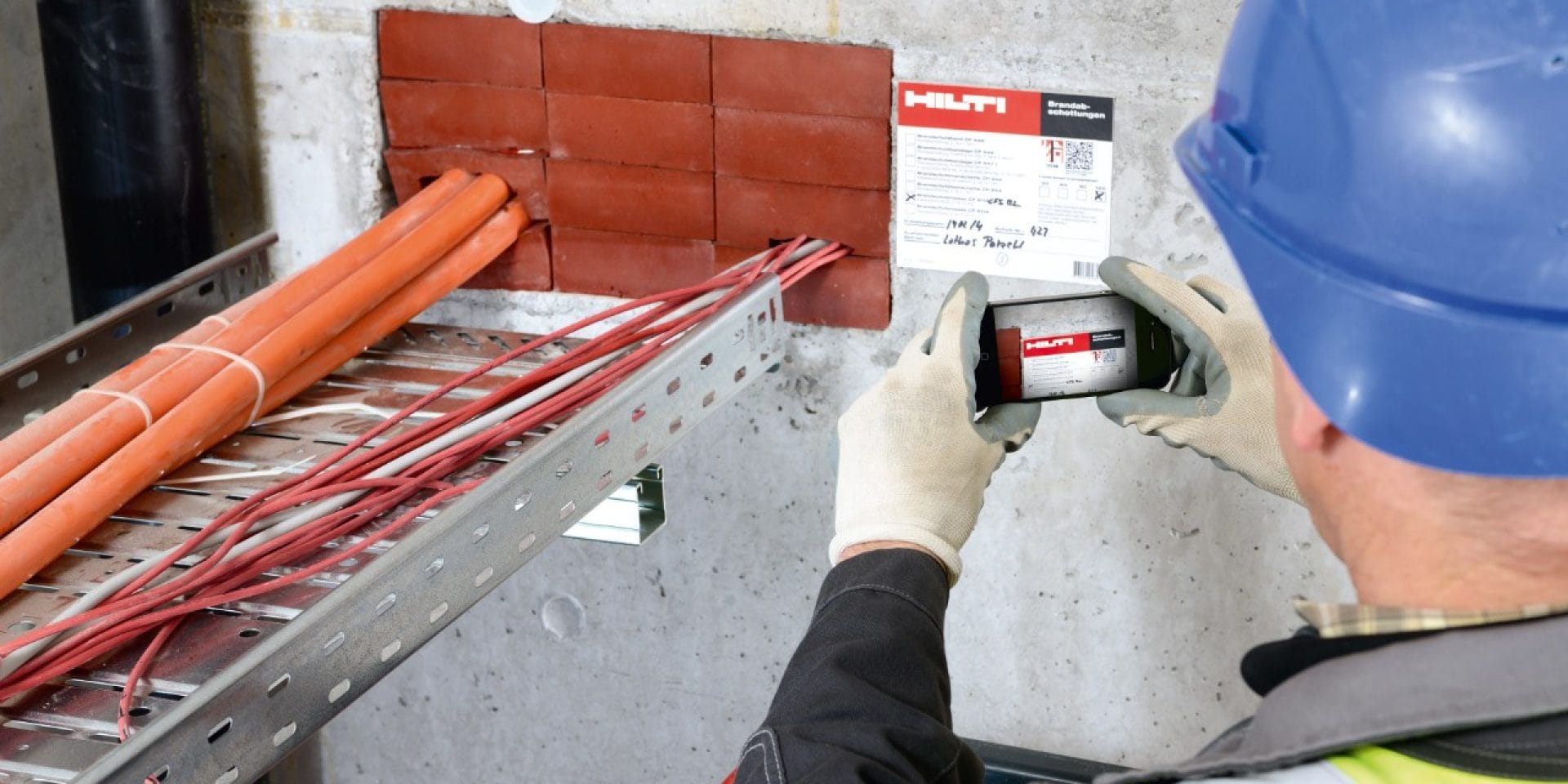 Un operario fotografía la documentación de protección contra incendios de Hilti con su teléfono